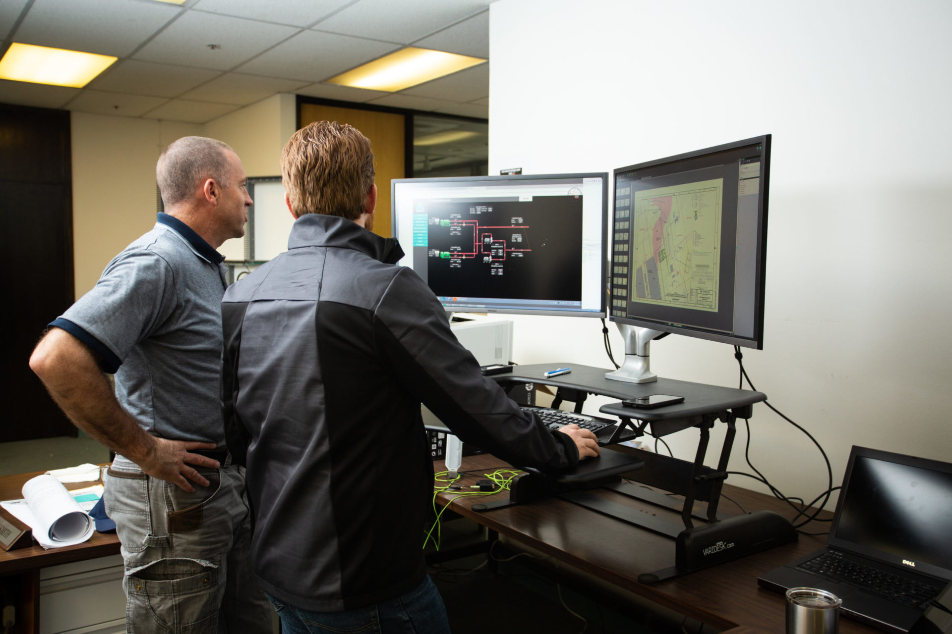 two men looking at design on computer