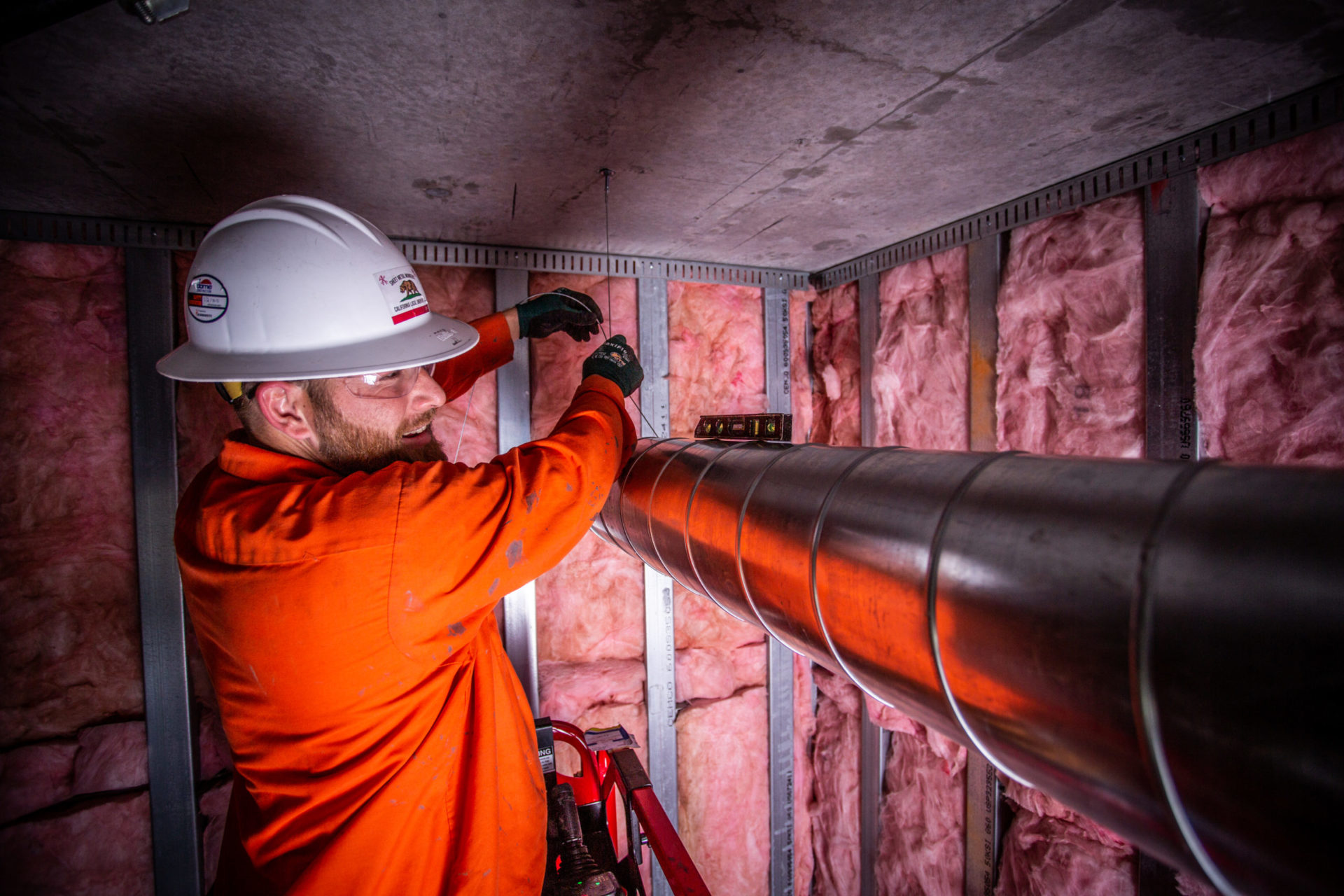 Worker installing duct