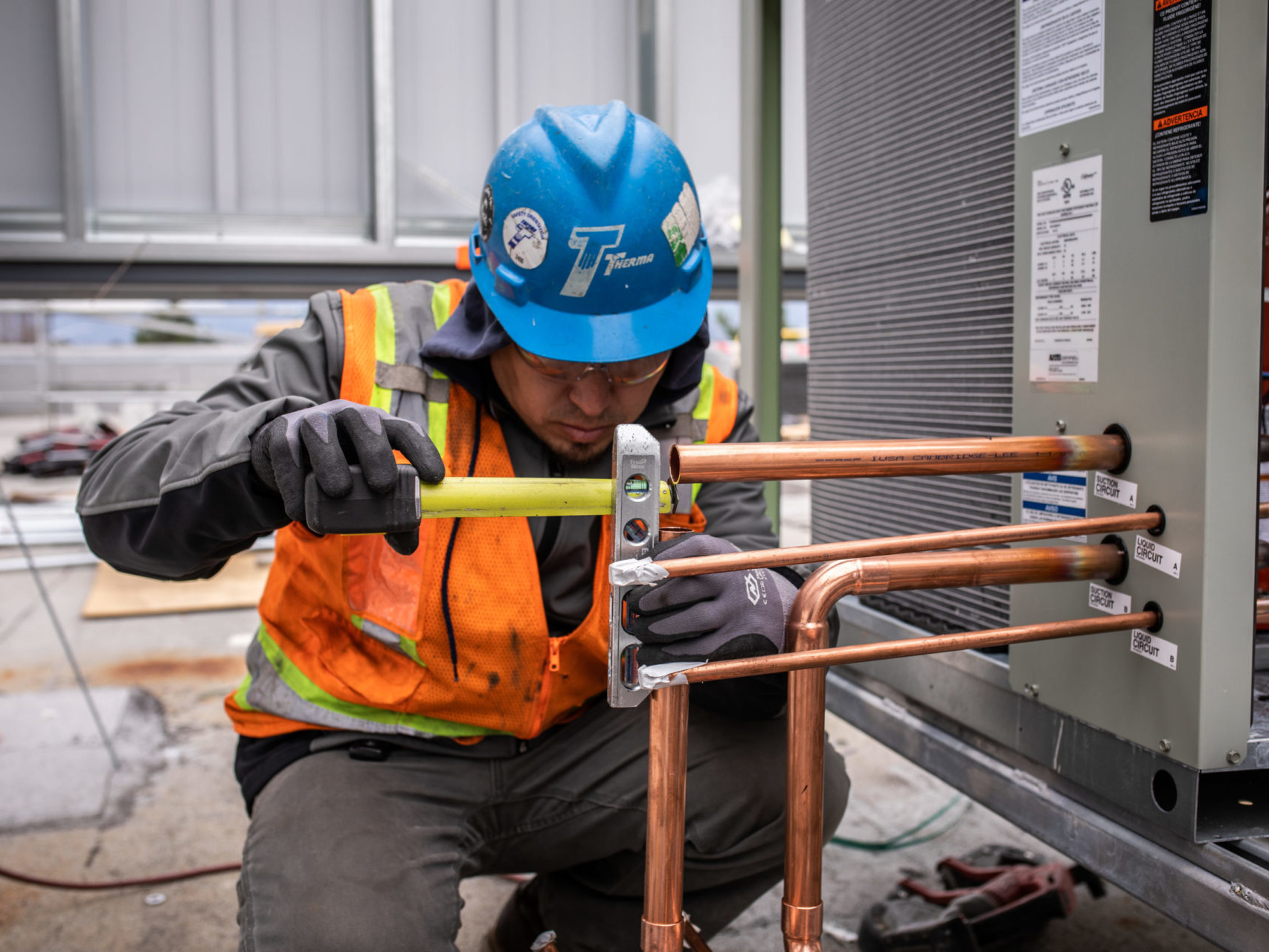 Worker measuring pipes