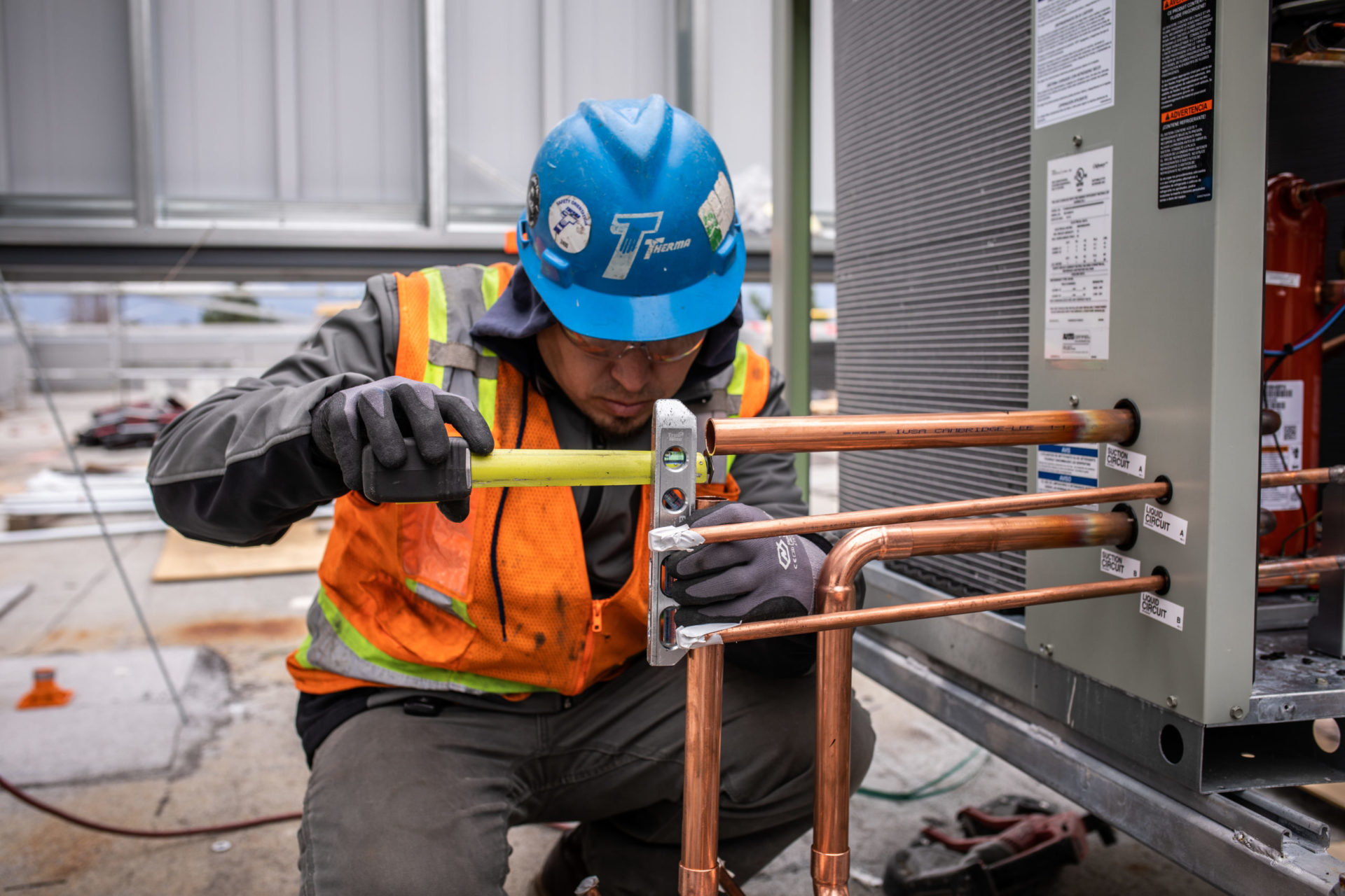 Worker measuring pipes
