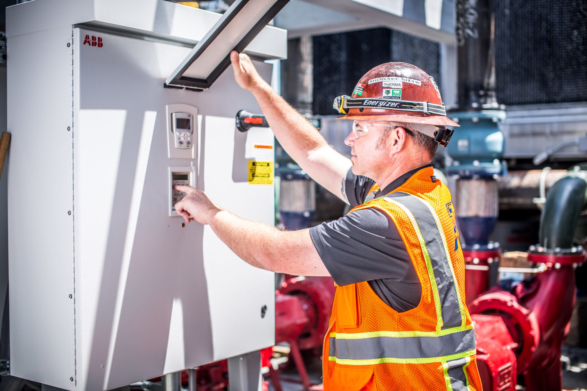 worker inputting code in control box