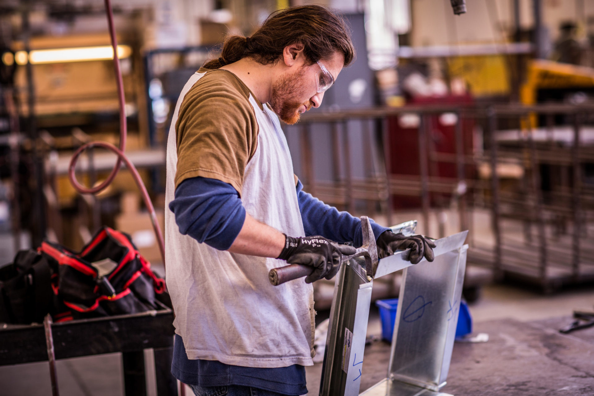 Man working with metal sheets in workshop