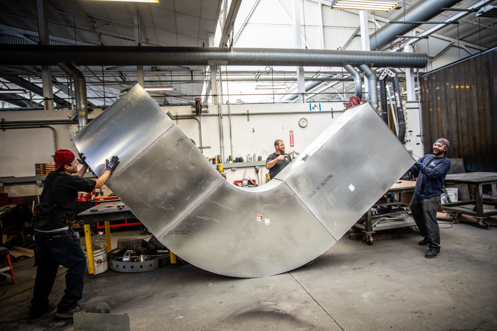 Workers building huge metal ducts