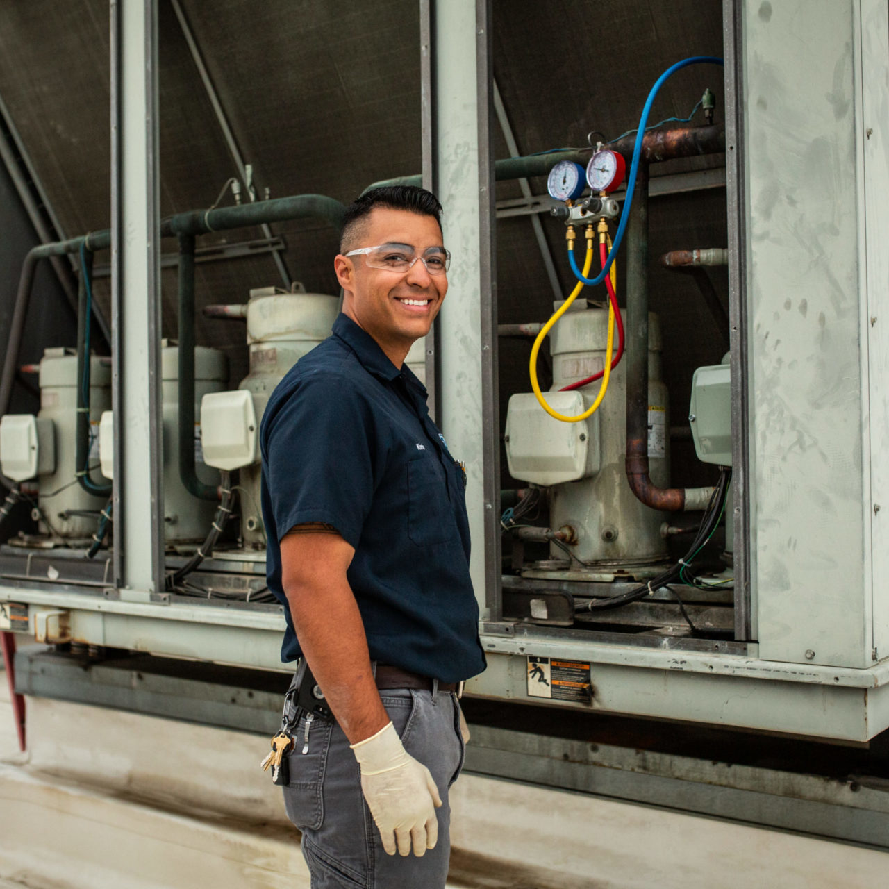 man smiling in front of machine