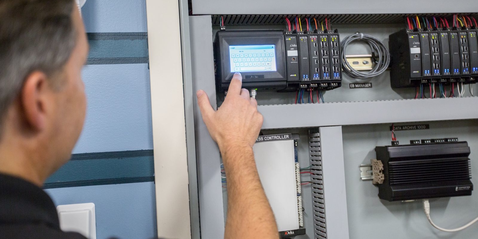 Man operating direct digital control panel
