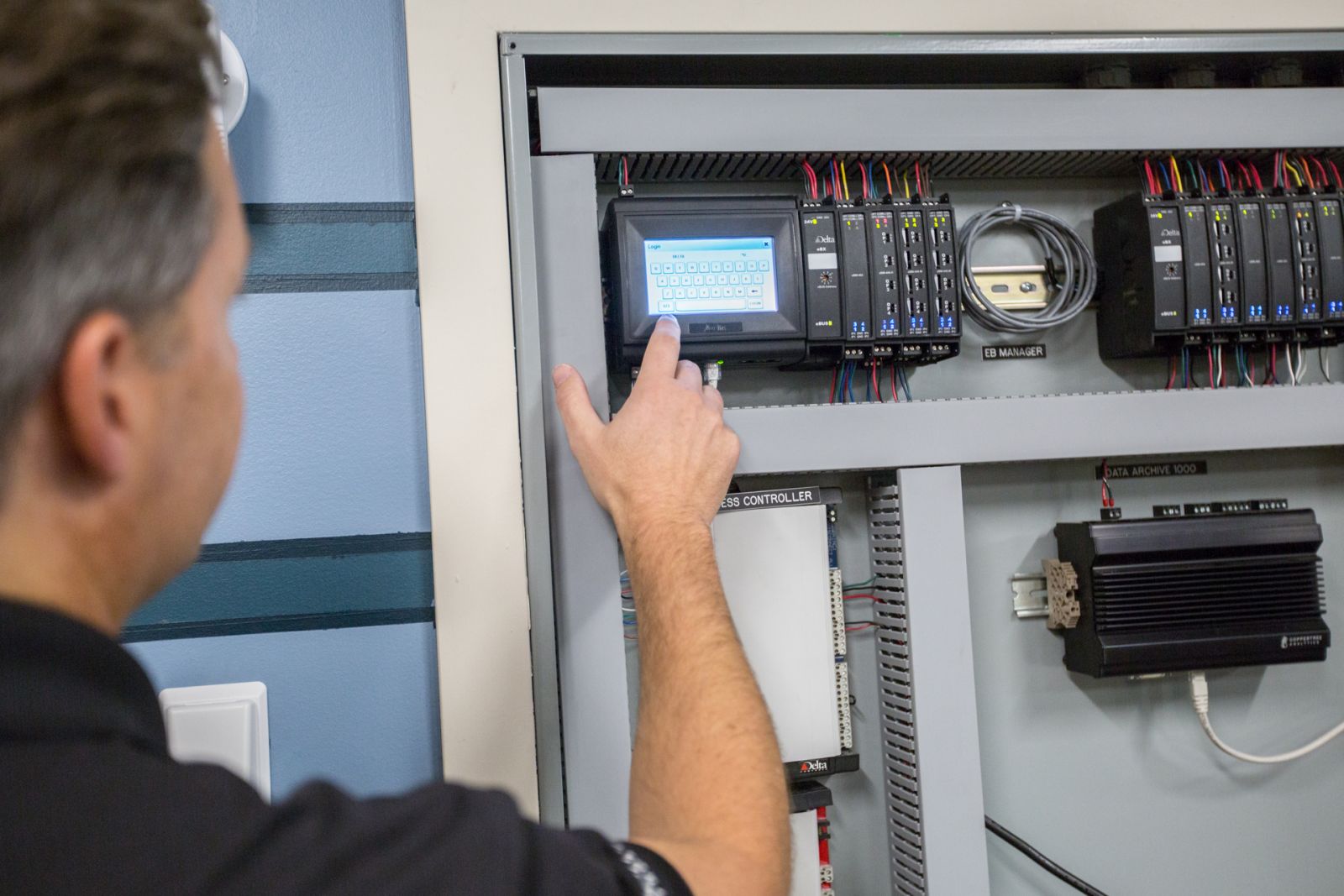 Man operating direct digital control panel