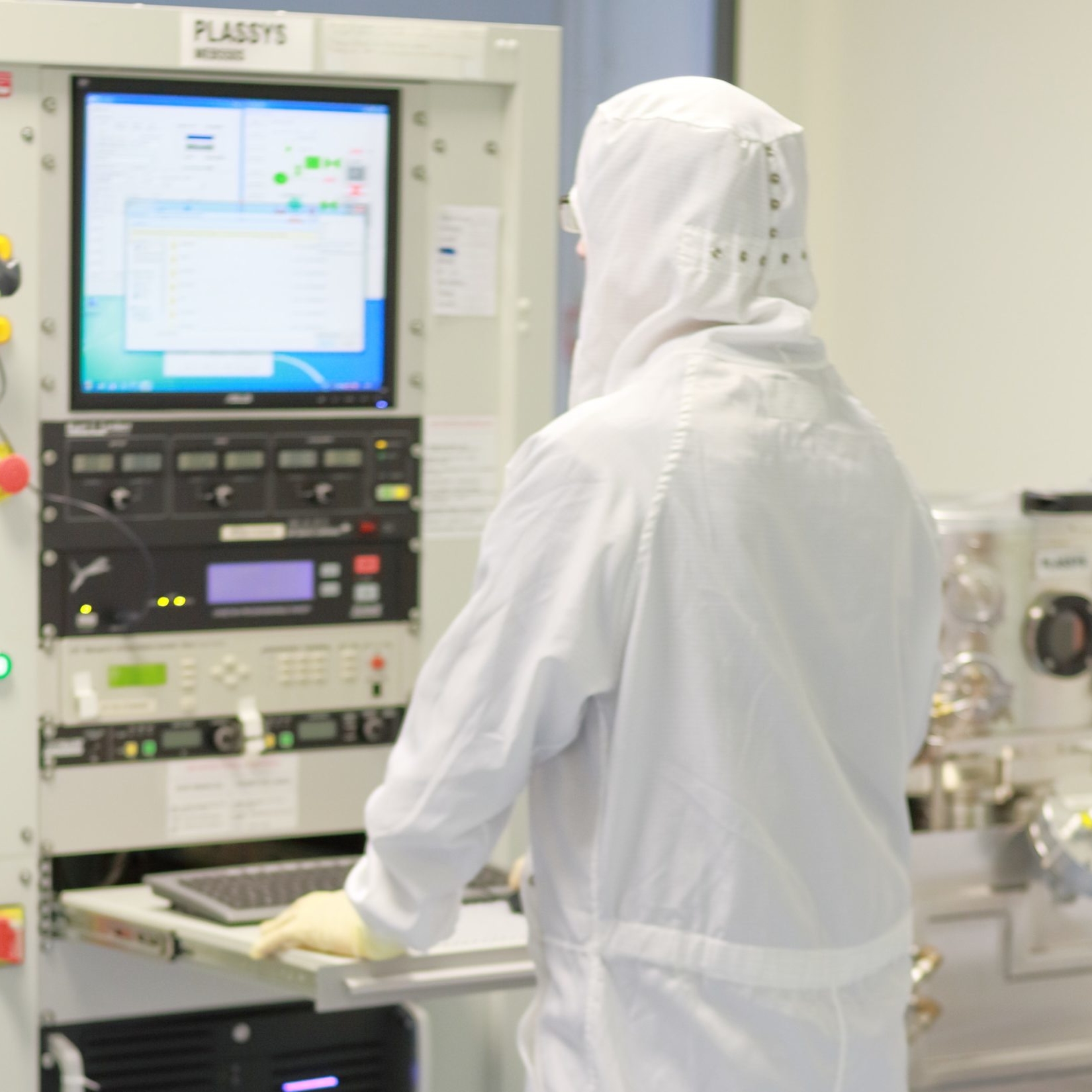 Professional in CleanRoom wear working in computer