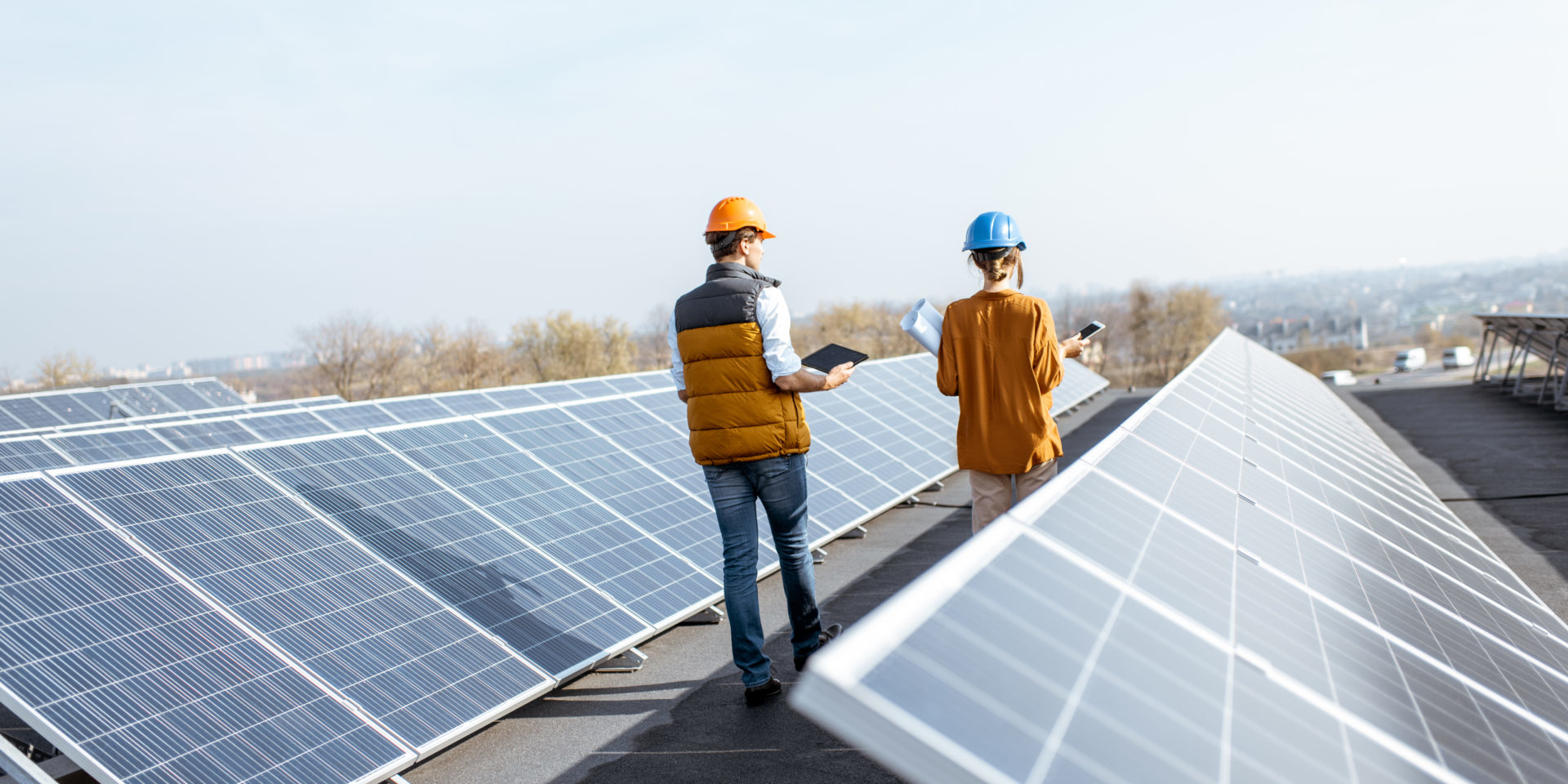 Two workers checking solar panels