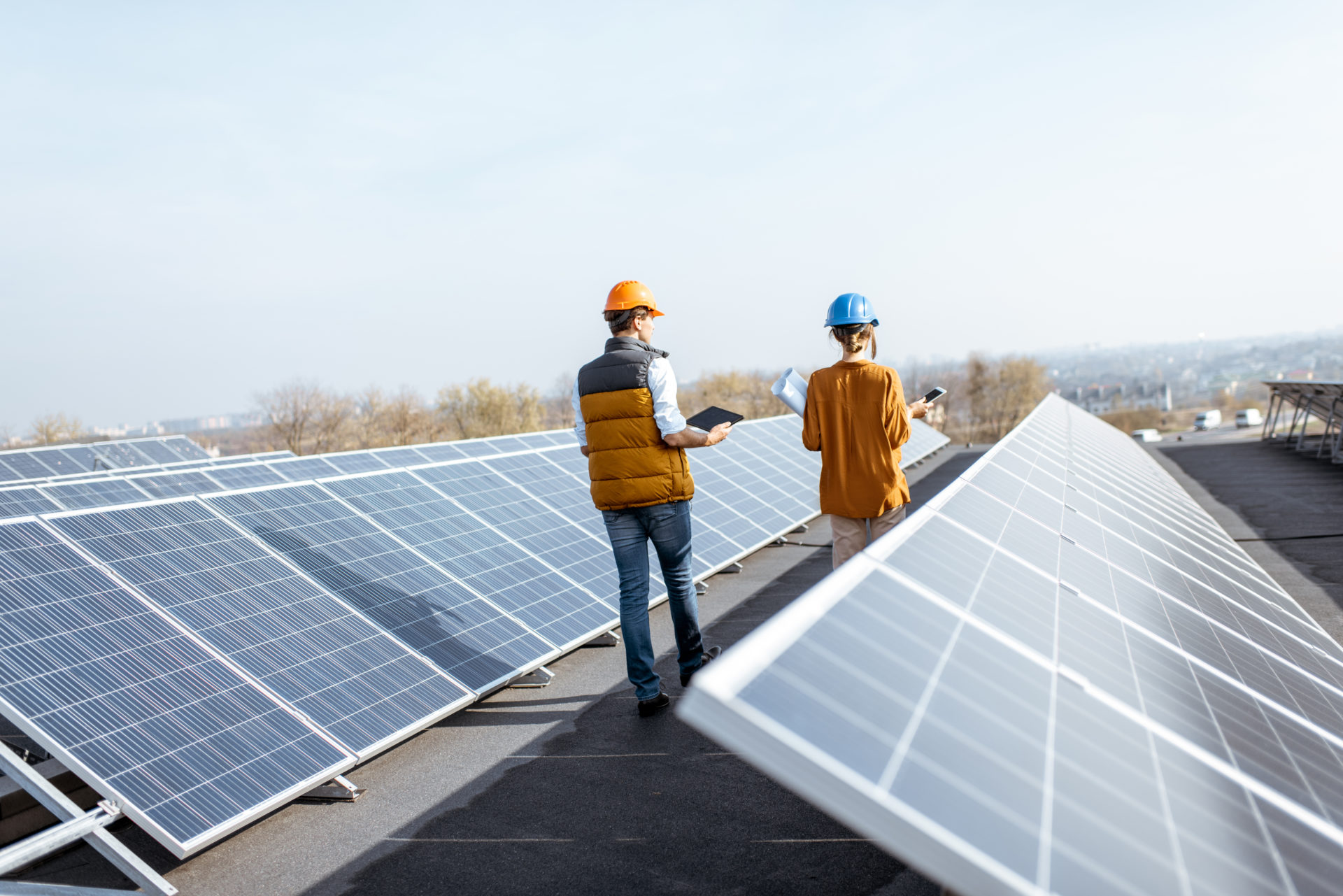 Two workers checking solar panels