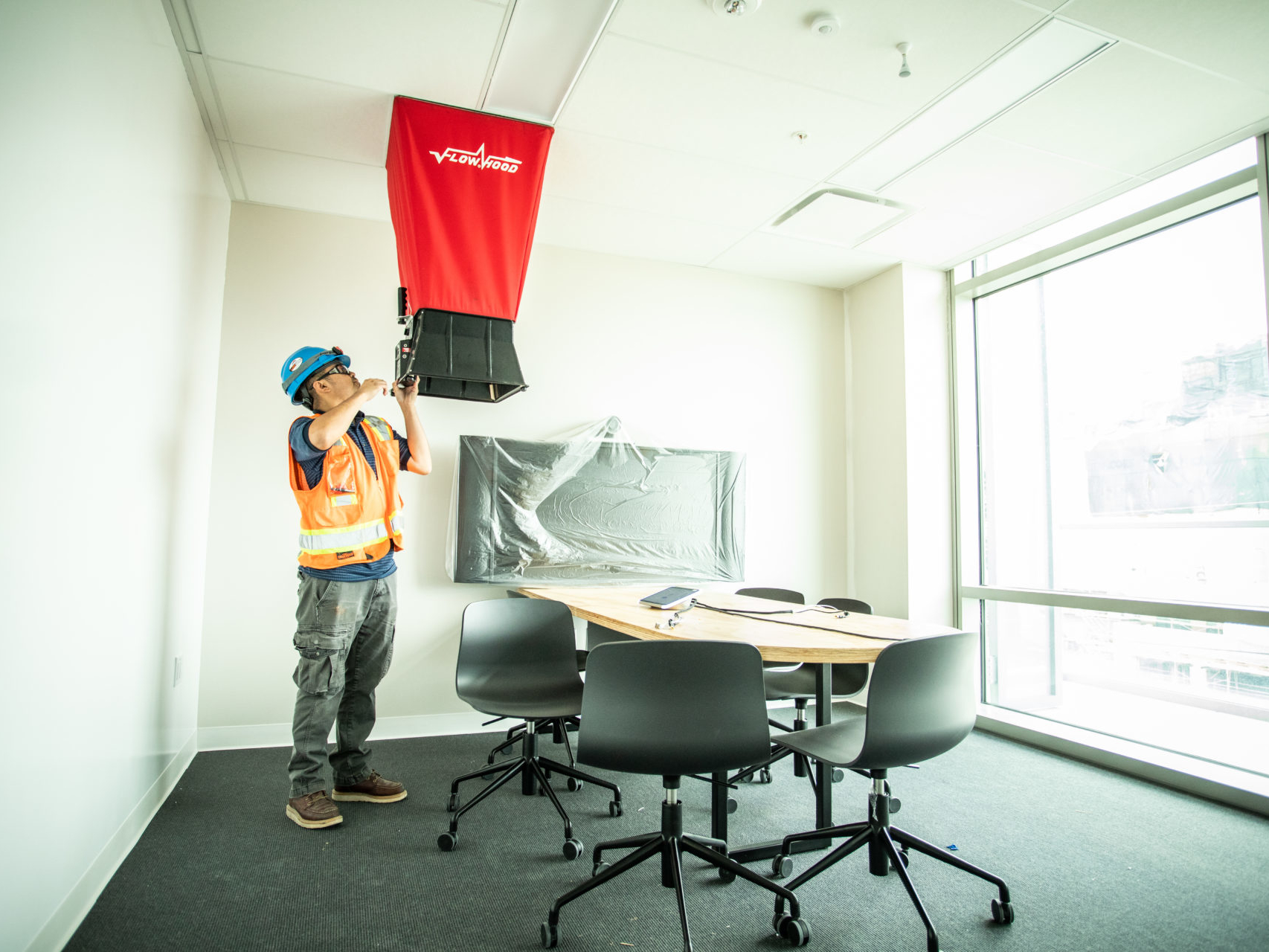 Worker checking air flow hood